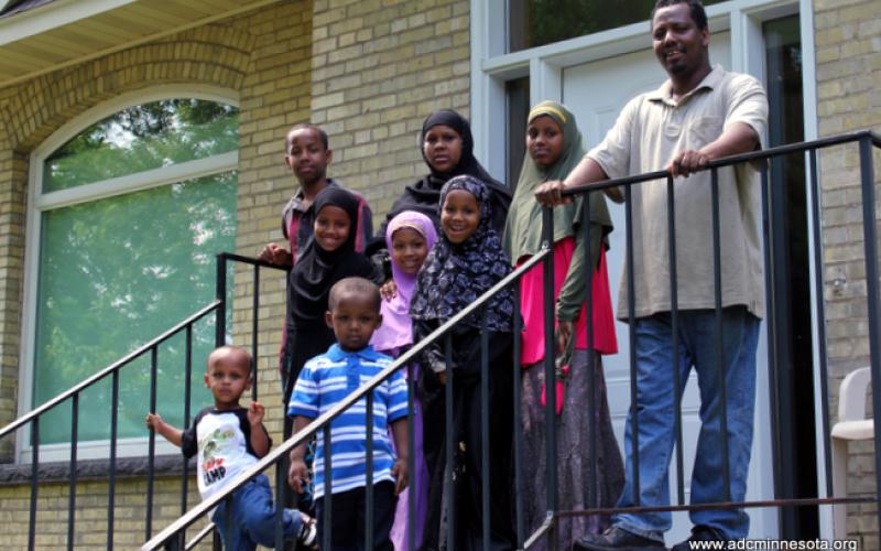 Somali family outside their newly-purchased home in St. Cloud, MN