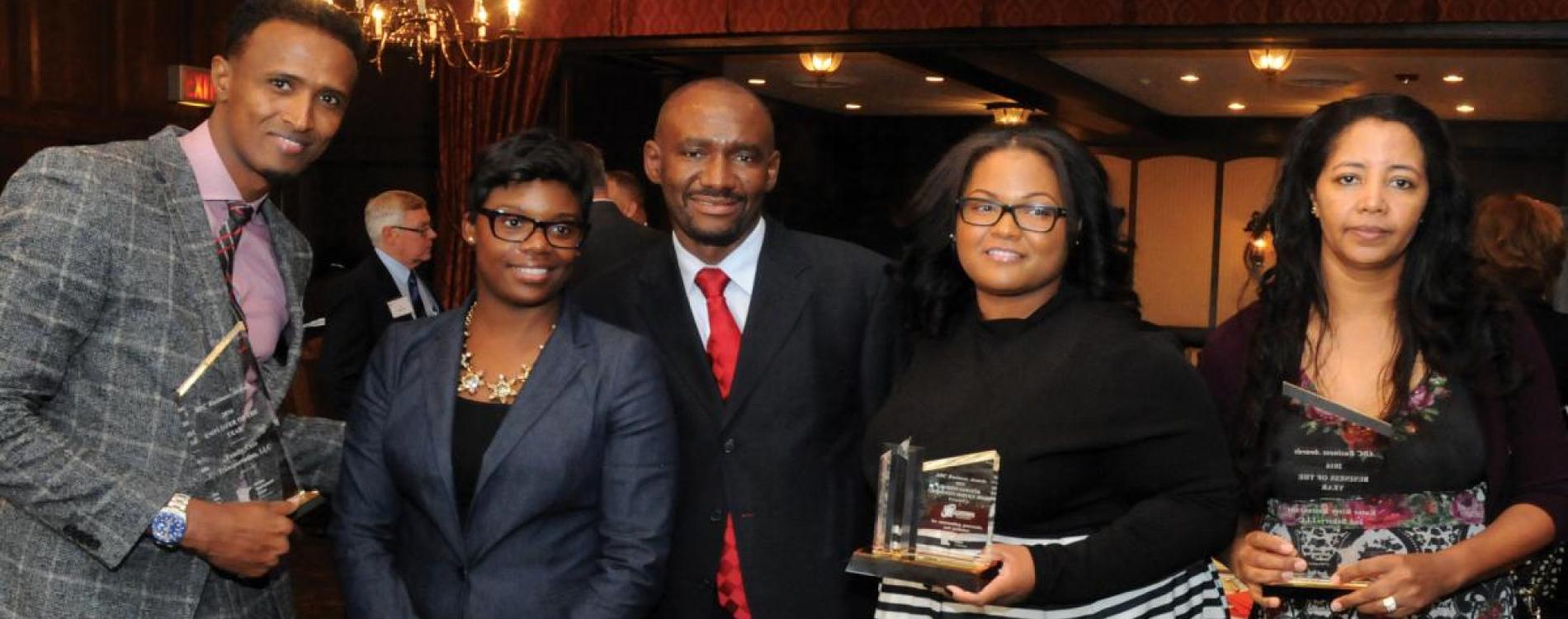 Award winners at ADC luncheon stand with Executive Director Nasibu Sareeva