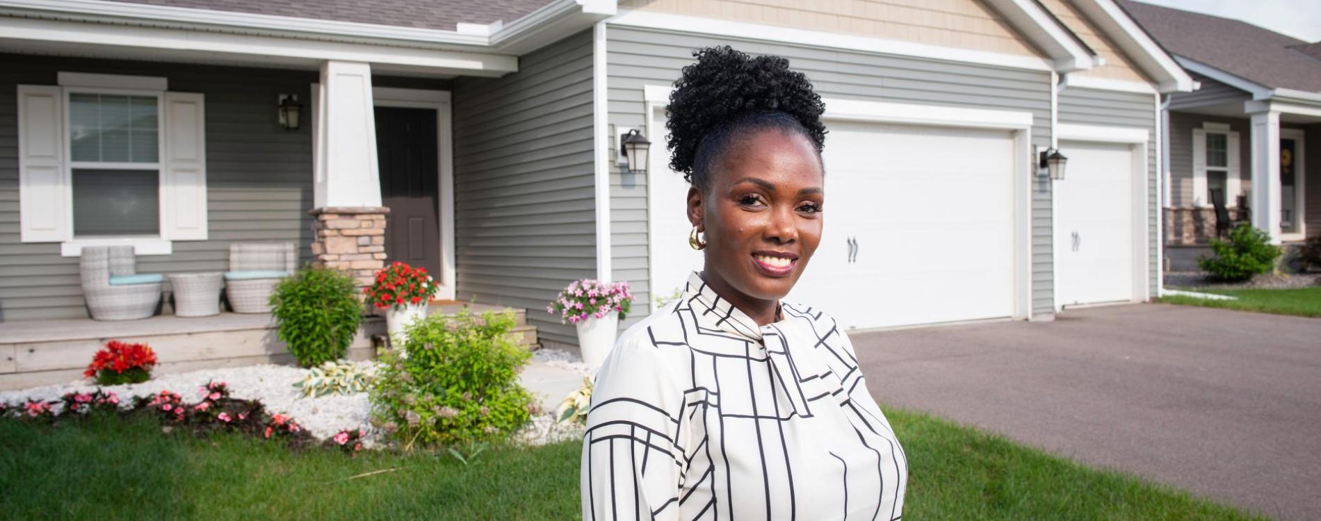 One of ADC’s most accomplished clients stand in front of her recently purchased home